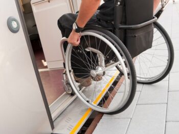 A home ramp being accessed by a person in a wheelchair.